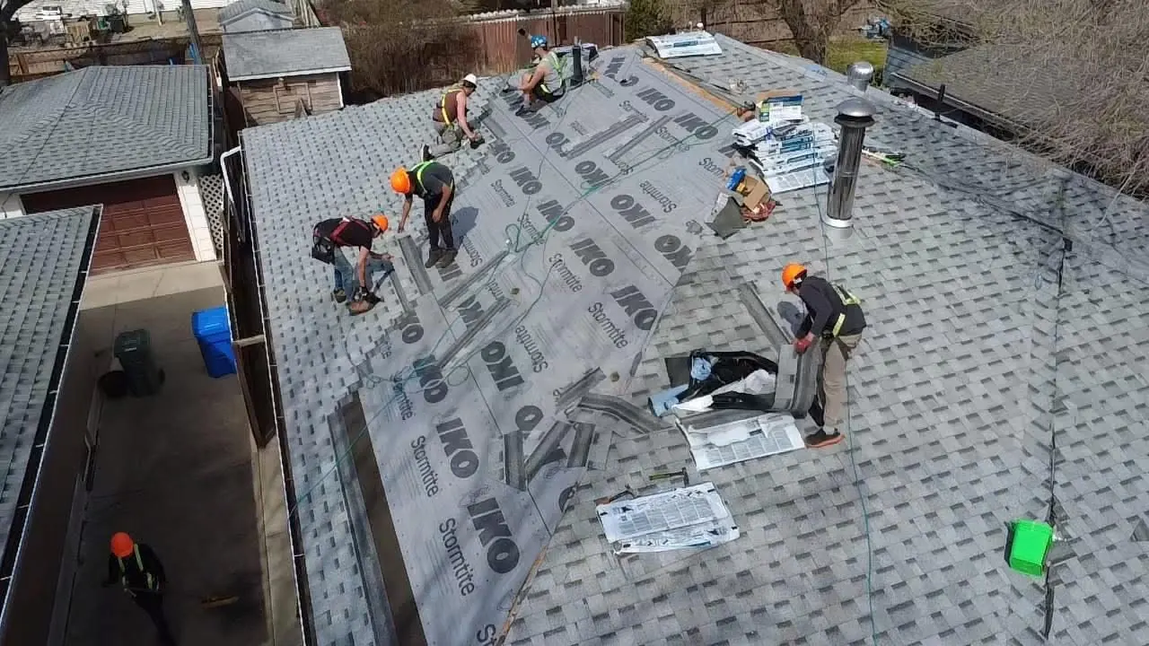 Makan Roofing crew installing IKO underlayment on a roof replacement in Regina Saskatchewan
