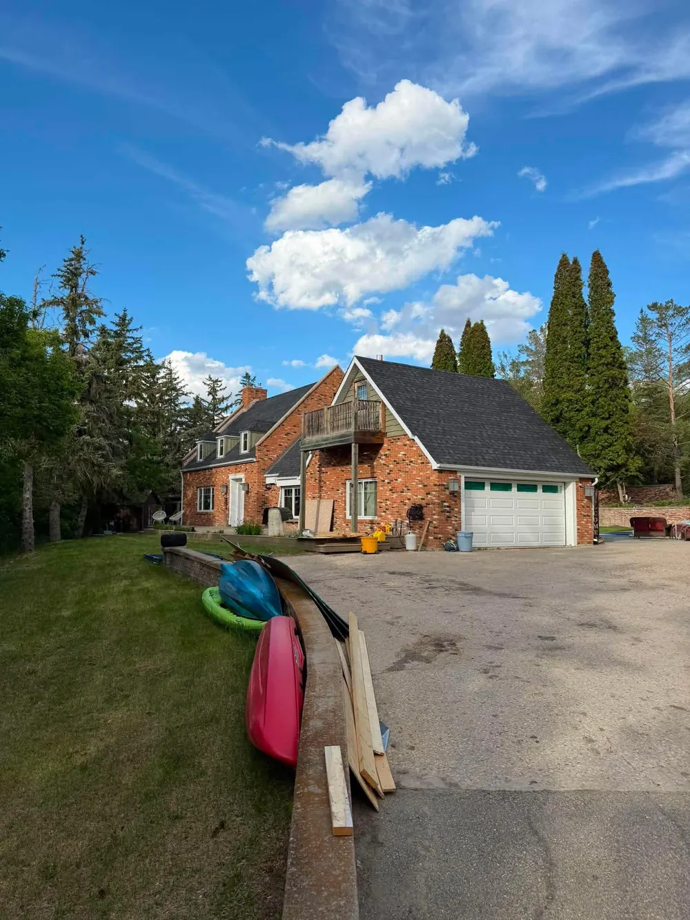 Completed asphalt shingle roof replacement on brick home in Regina Saskatchewan