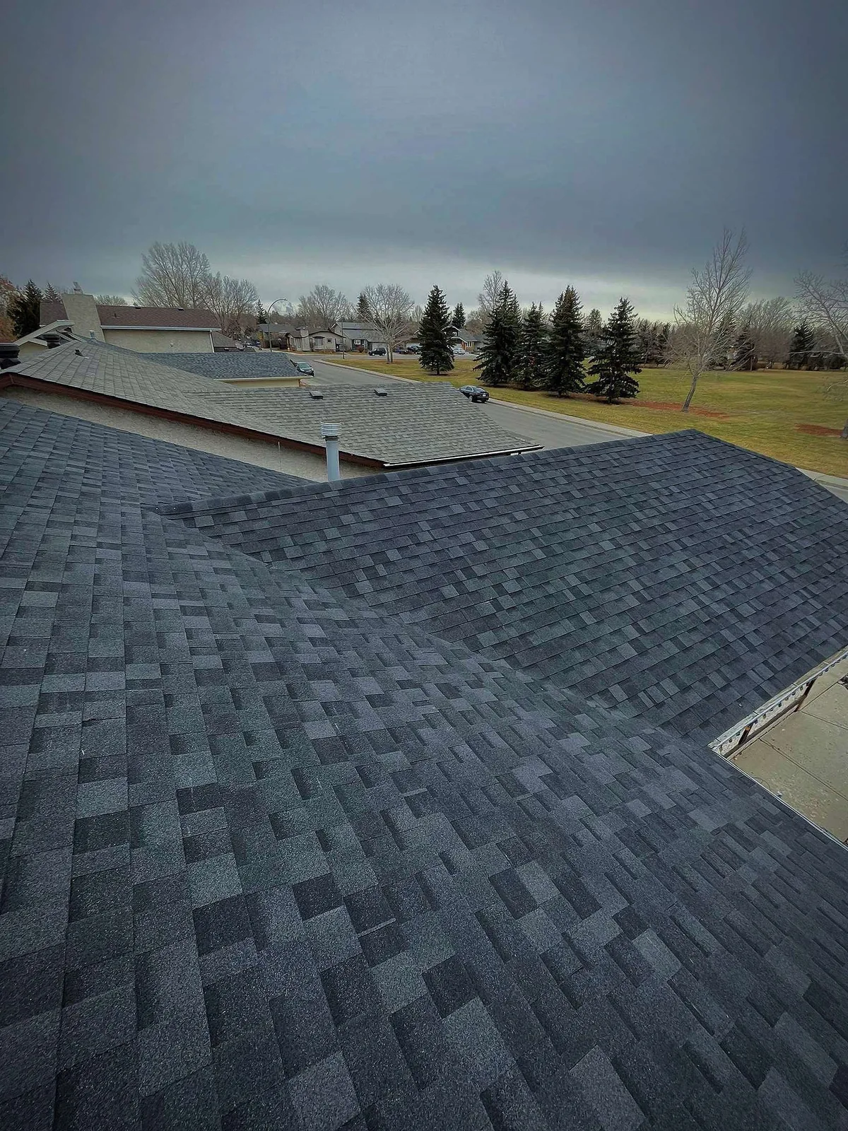 Completed charcoal asphalt shingle roof on Regina home by Makan Roofing