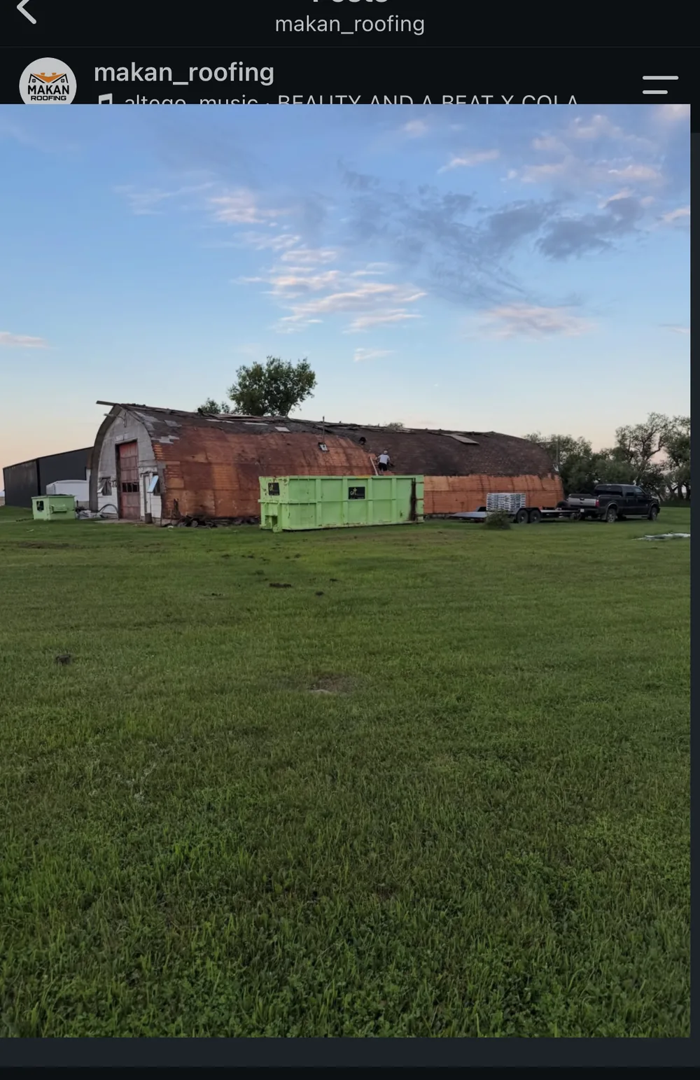Commercial quonset barn before roof replacement, worn shingles and aging deck, near Regina Saskatchewan